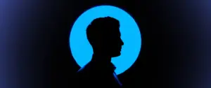 Silhouette of a person against a vibrant blue circular background, creating a striking contrast and visual intrigue.