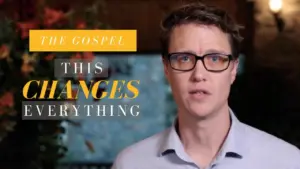 Man wearing glasses discussing the impact of the Gospel, with emphasized text "This Changes Everything" in a lively setting.