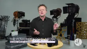 Man explaining social media's influence, surrounded by studio lighting and equipment, with a focus on communication tools.