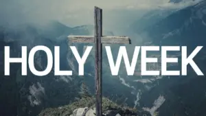 Scenic mountain backdrop featuring a wooden cross with bold text overlay reading "Holy Week."