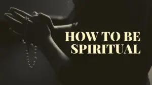 Person clasping hands in prayer, with a spiritual theme highlighted by the text "How to Be Spiritual."