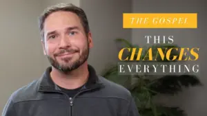 Man smiling in a casual setting with text overlay "The Gospel This Changes Everything" and a green plant in background.