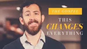 Man with a beard smiling, presenting the message "The Gospel: This Changes Everything" in an engaging setting.