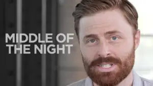 Man with a beard speaking directly to the camera, text overlay says "MIDDLE OF THE NIGHT." Soft lighting enhances mood.