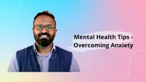 Smiling man sharing mental health tips for overcoming anxiety against a colorful background.