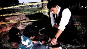 A detective crouches beside a child at a crime scene, surrounded by yellow caution tape and a fallen tree.