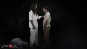 A dramatic scene depicting a tall, bearded figure in white reaching out to a shorter man against a dark backdrop.