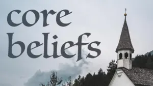 White church steeple against a cloudy sky, with the words "core beliefs" prominently displayed in the foreground.