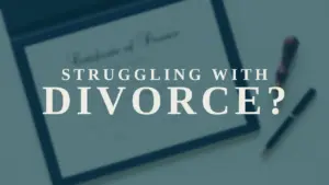 Table with a divorce document and a pen, highlighting the question "Struggling with Divorce?" for emotional support.