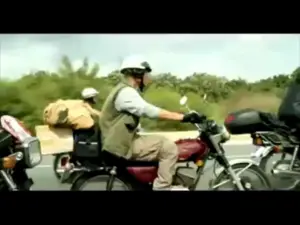 Motorcyclists riding on a highway, featuring scenic greenery and a sunny sky, showcasing adventure and freedom.