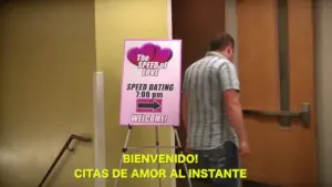 Speed dating event sign welcoming participants, featuring bright colors and clear instructions, with a person entering the venue.