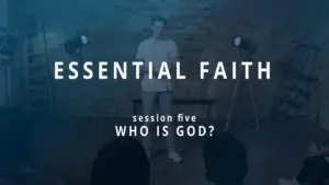 Young presenter speaking on stage about essential faith, focusing on the theme "Who Is God?" in a workshop setting.