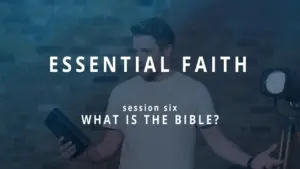 Man holding a Bible during a session titled "What is the Bible?" from the Essential Faith series, with a modern background.