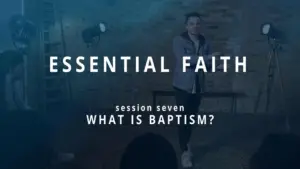 Man presenting a talk on baptism during an "Essential Faith" session in a well-lit studio setting.