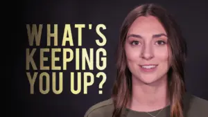 Young woman smiling with text overlay asking, "What's keeping you up?" against a dark background.