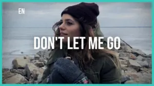 Young woman in a beanie, looking contemplative by the water, with the text "DON'T LET ME GO" overlaid.