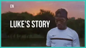 Young man in a Nike shirt standing outdoors at sunset, looking thoughtful, with the text "Luke's Story" prominently displayed.