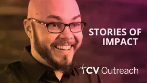 A smiling man with glasses showcasing the CV Outreach logo and the text "Stories of Impact" in an engaging design.