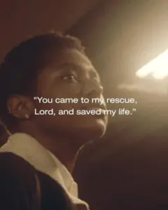 Person gazing thoughtfully with warm lighting, featuring an uplifting quote about rescue and salvation.