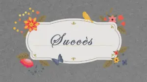 Colorful floral decorations surround the word "Succès" on a textured gray background, conveying a cheerful vibe.