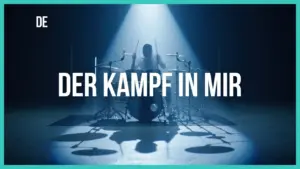 A drummer performing under dramatic lighting with the text "Der Kampf in Mir" prominently displayed.