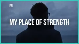 Silhouette of a person looking out at the sea under a cloudy sky with the text "My Place of Strength" overlayed.