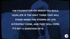 Inspirational quote on resilience, with a speaker in a suit against a blue backdrop, emphasizing life's challenges and foundations.