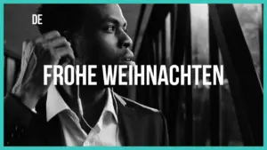 A man in a suit listening to music, gazing thoughtfully out of a window, with "Frohe Weihnachten" in bold text.