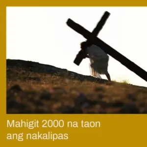 Silhouette of a person carrying a cross at sunset, symbolizing sacrifice and reflection on over 2000 years of history.