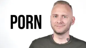 Smiling man with short hair beside the word "PORN" in bold, showcasing a provocative theme in a minimalist style.