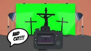 Camera focused on a silhouette of a crucifix against a green screen, with a speech bubble saying "AND CUT!!!".