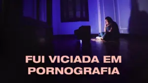 A person sitting alone in a dimly lit room, reflecting on addiction to pornography. Blue tones create a somber mood.