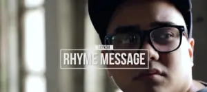 Close-up of a young person wearing glasses and a cap, with the text overlay "Rhyme Message" in a stylish font.