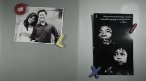 Black and white photos of a couple and a woman with a child, displayed on a gray wall with colored magnets.