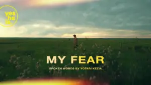 A person stands alone in a green field under a dramatic sky, with "My Fear" text overlay highlighting the spoken word theme.