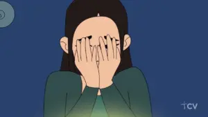 Animated character with long dark hair hiding face with hands, expressing emotions against a blue background.