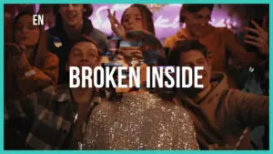 Group of friends enjoying a lively party, with the phrase "Broken Inside" prominently displayed in bold text.