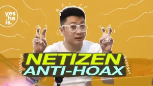 Young man in glasses gesturing in front of an orange background with the text "Netizen Anti-Hoax" displayed prominently.