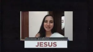 Woman smiling in front of a background with the word "JESUS" prominently displayed below her.