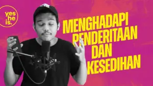 A young man speaking into a microphone against a vibrant pink background with Indonesian text about facing suffering and sadness.