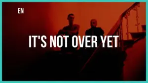 Dramatic image of two figures sitting on stairs with bold text saying "It's Not Over Yet" against a red background.