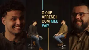 Two men engaged in conversation, reflecting on lessons learned from their fathers, set against a dark background.