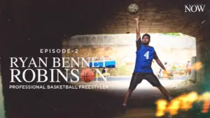 Professional basketball freestyler Ryan Bennett Robinson showcasing ball skills under a bridge in a dynamic pose.