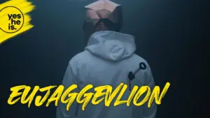 Person wearing a geometric mask and white hoodie, surrounded by dark mist, with vibrant "EujaggevLION" text.