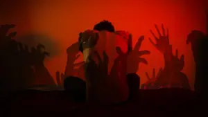 Silhouette of a person surrounded by eerie, outstretched hands against a striking red backdrop, creating a haunting atmosphere.