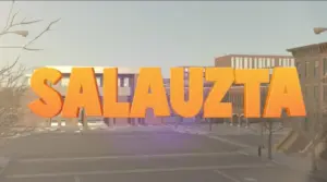 Bold orange text reading "SALAUZTA" in an urban setting with buildings and a clear sky in the background.