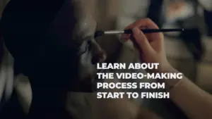 Person applying makeup on a model's face, with text about the video-making process overlaying the image.