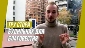 Young man speaking outdoors with modern buildings in the background, promoting a charitable initiative in a casual setting.