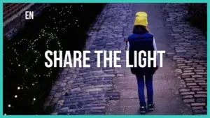 Child in a yellow hat walking down a lit cobblestone path with the text "Share the Light" prominently displayed.