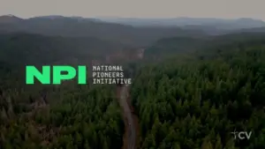 Aerial view of lush green forests with the NPI logo overlayed, representing the National Pioneers Initiative.